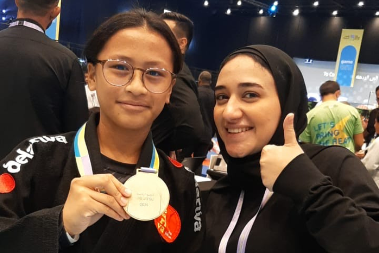 UAE Student Jiu Jitsu Champion Zoe Proudly Holding her Gold Medal after her win.