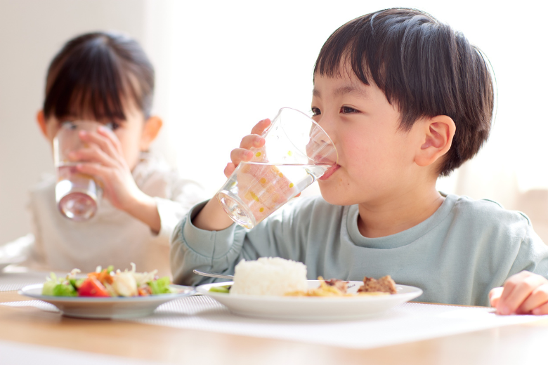 Young child keeping up with his water intake