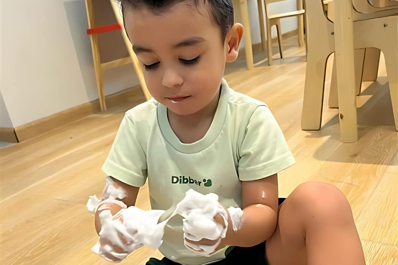 Child of determination at Dibber nursery engaging in sensory play to support cognitive development
