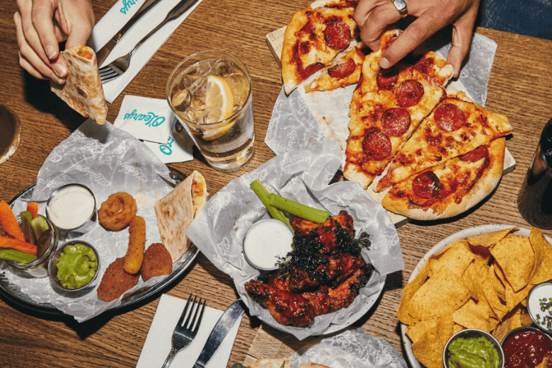 American-style sharing platters including wings, pizza, and nachos at O’Learys Sports Bar in Dubai