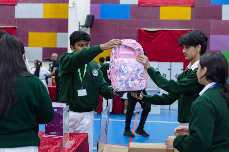 Students hold Skechers-donated schoolbags during the Students for Students 2025 volunteer event.