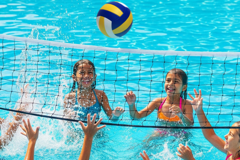 Kids playing water volleyball at Al Ain Adventure's summer camp