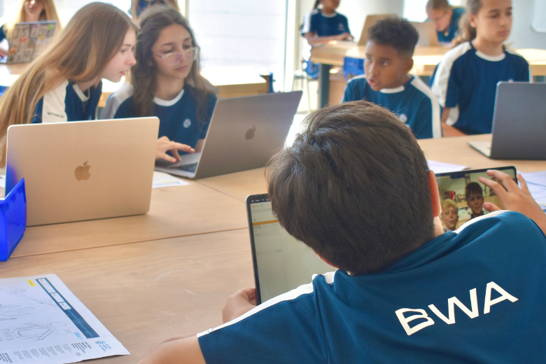 Bloom World Academy students using digital devices in class as part of AI and digital wellbeing education