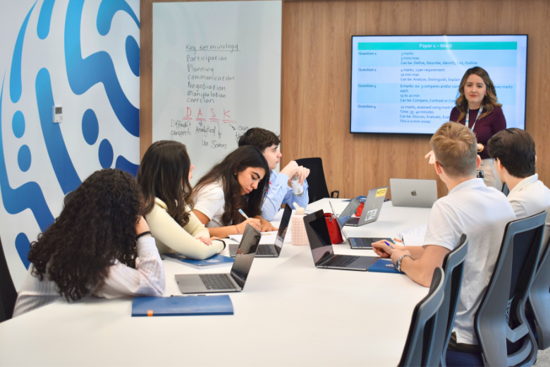 Bloom World Academy students engaging in a digital wellbeing and AI literacy lesson, guided by a teacher during an interactive classroom session.