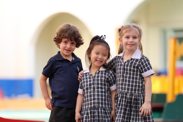 Smiling young students in uniform at Brighton College UAE, reflecting a caring and inclusive pastoral environment.