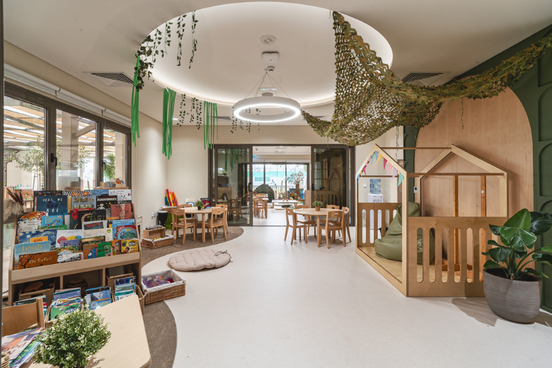 Nature-inspired classroom with wood elements, greenery, and child-sized seating