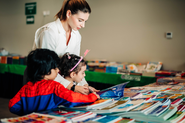 Teacher guiding students through a reading session at North Gate British School, Ajman.