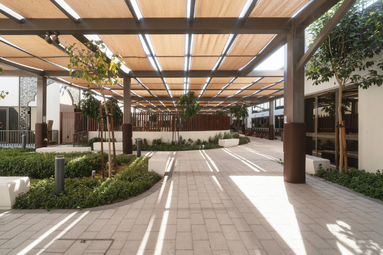 Shaded central courtyard of Rashid and Latifa School with integrated greenery and modular architecture