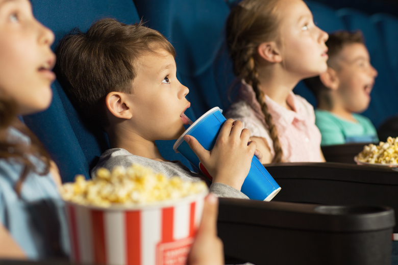 Children enjoying a private cinema screening at Studio One Hotel with popcorn and drinks