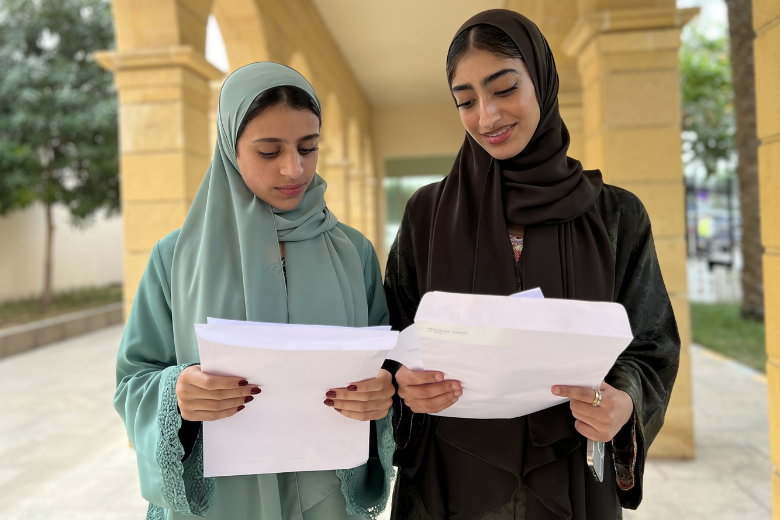 Brighton College Abu Dhabi pupils celebrate their GCSE success in 2025 while looking over their results.