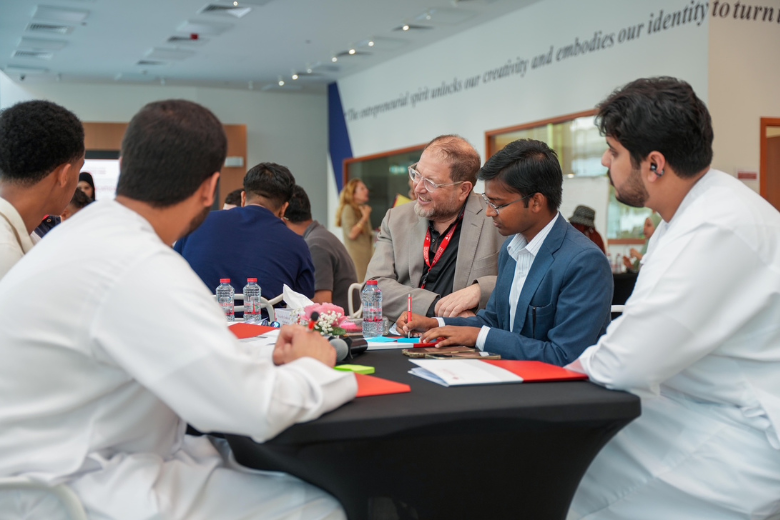 Students at Canadian University Dubai engaging in a business analytics discussion during a class activity.