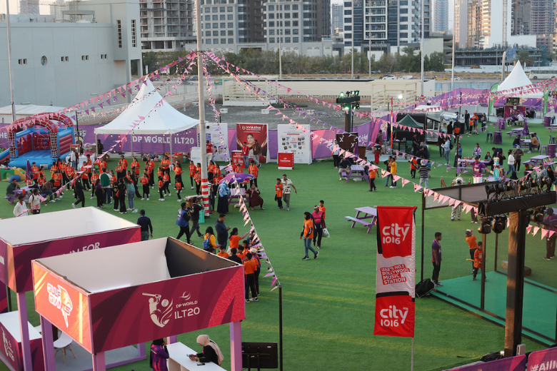 Wide view of the DP World ILT20 stadium carnival with colourful booths, activities, and family entertainment in Sharjah.