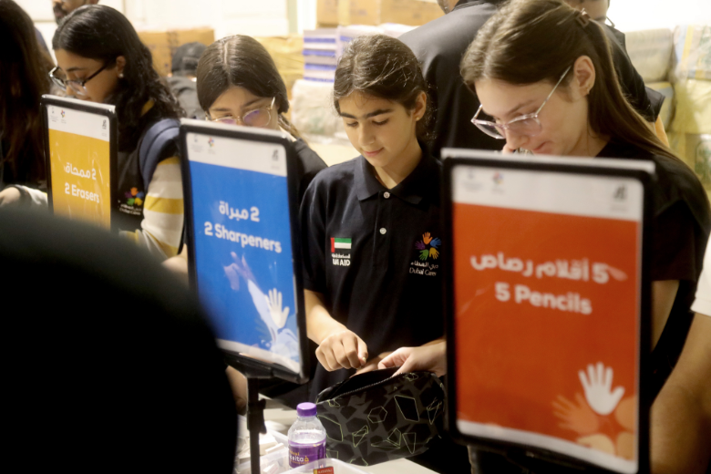 Students and volunteers assemble school kits during Dubai Cares and Aldar Volunteer Emirates Back to School initiative in Abu Dhabi.