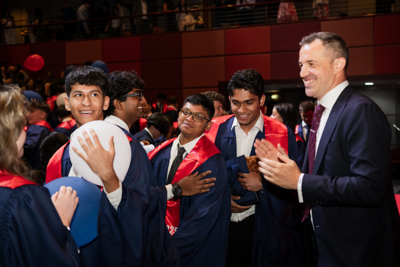 Dubai College students celebrating their A Level results with Headmaster Tomas Duckling.