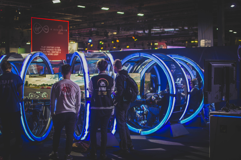 Gamers competing in a Dubai esports tournament with immersive simulator pods.