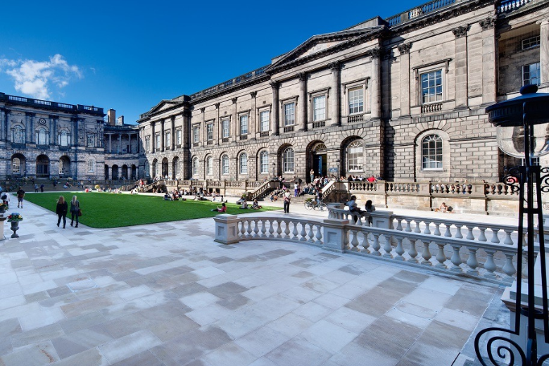 University of Edinburgh Old College courtyard with students relaxing on the lawn