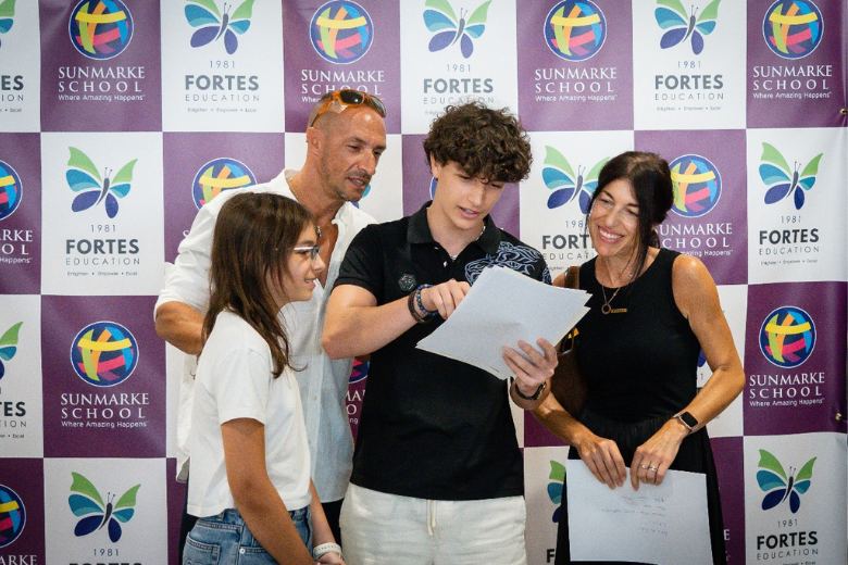 Sunmarke School students smiling as they review GCSE results together in 2025