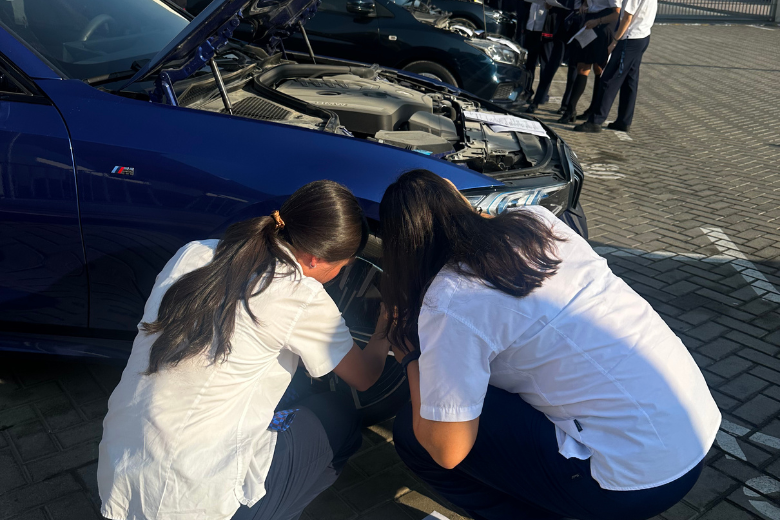 Students in the UAE practising tyre changing with guidance from The Mobile Mechanic during a hands-on life skills session