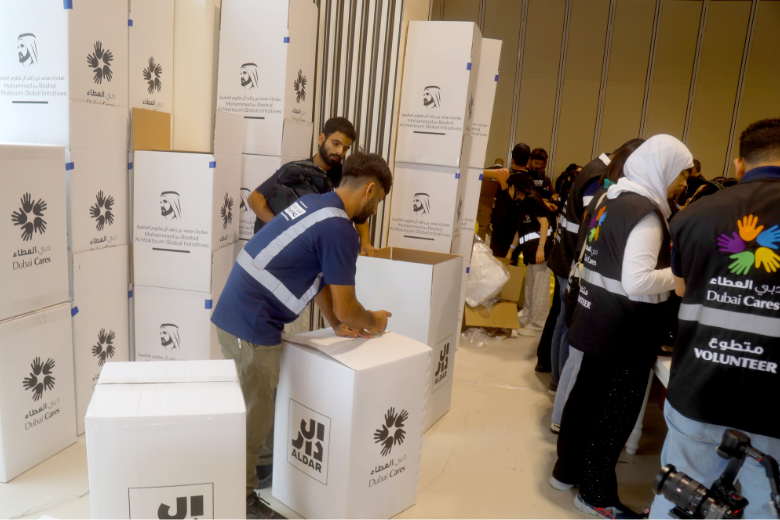 Volunteers pack Aldar and Dubai Cares boxes with school essentials for distribution to UAE students.