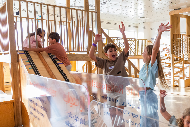 Children celebrating as they play with ramps and ball runs at OliOli® Incredi-Balls gallery