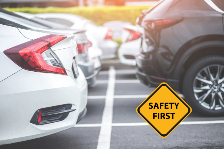 Cars parked in school lot with “Safety First” sign under UAE school drop-off and pick-up guidelines.