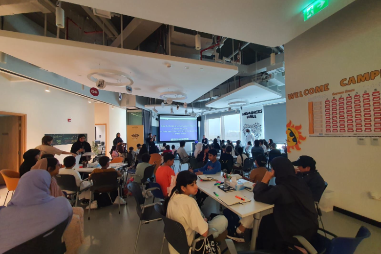 EStars leads an esports workshop in Abu Dhabi at the Creative Lab Yas Creative Hub with young learners and mentors in a full room