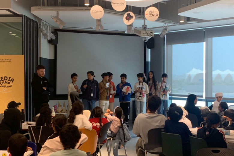 Students share game ideas on stage during the EStars esports workshop in Abu Dhabi