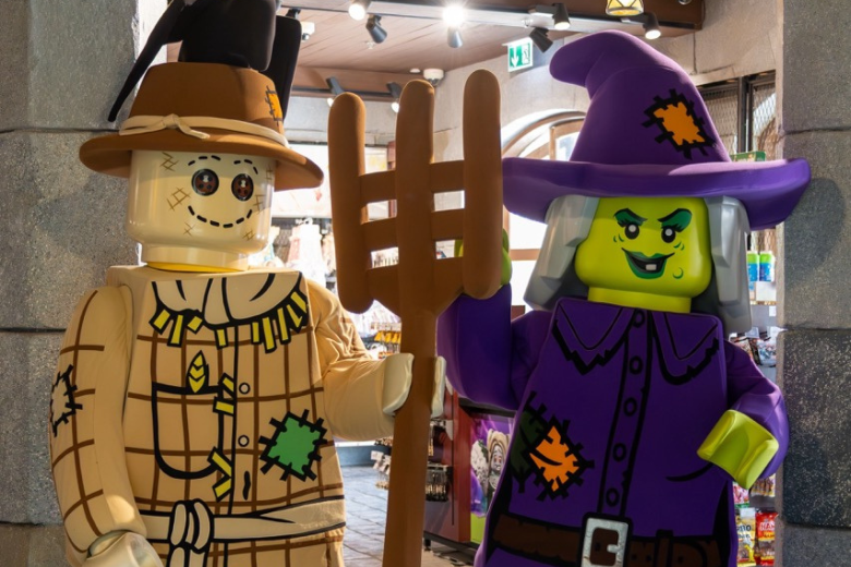LEGO Witch and Scarecrow characters greeting families during Halloween celebrations at LEGOLAND Dubai Resort
