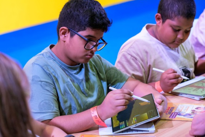 A student in the UAE using a Huawei tablet with a stylus during a digital learning workshop by Huawei and 51Talk.
