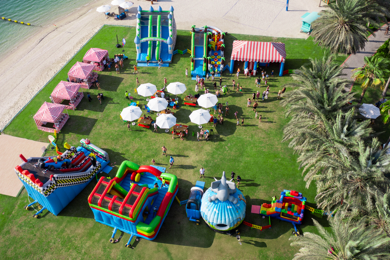 Enjoy an array of attractions including obstacle courses, bouncy castles, slides, and a bubble workshop, alongside a tempting selection of treats such as cupcakes, grilled corn, burgers, and cotton candy.