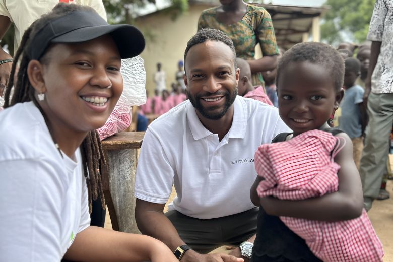 Crowds of children receiving donated Kapes uniforms at Togo school