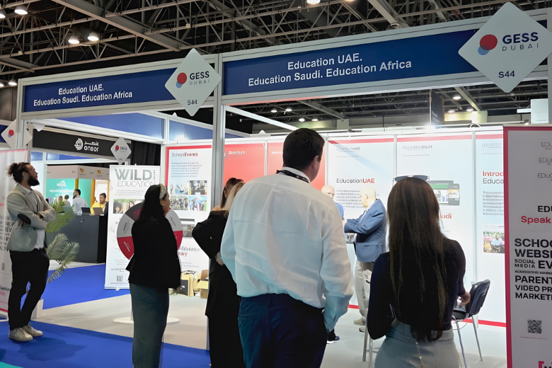 Minerva Virtual Academy students demonstrating the racing simulator at the GESS Dubai 2025 exhibition.