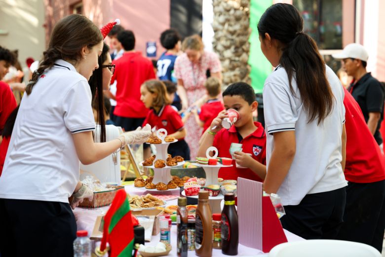 Students at Dwight School Dubai running stalls at the Winter Fayre