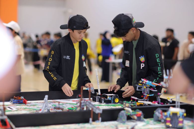 Students presenting robotics projects at FIRST LEGO League UAE finals