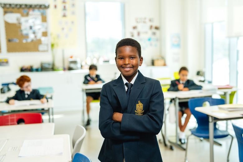Pupil actively participating in a classroom lesson, engaging with learning materials and teacher guidance