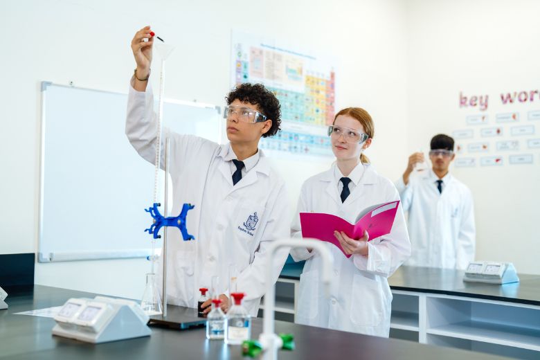 Students participating in hands on science experiments inside advanced school laboratory facilities