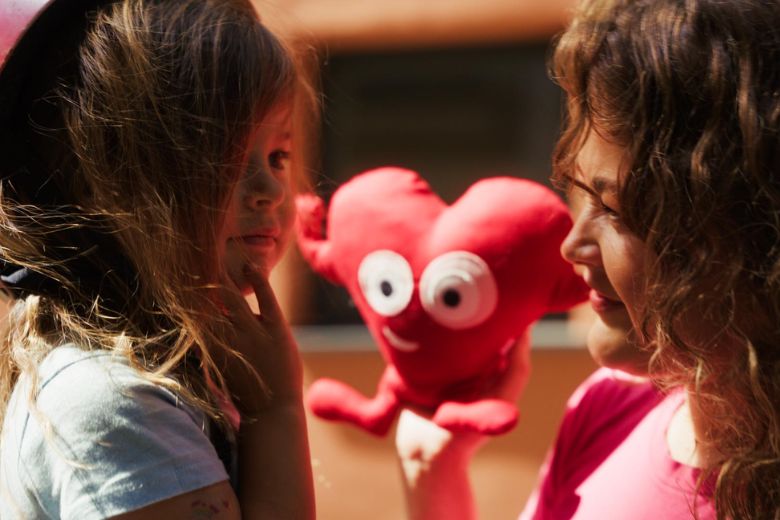 Parent participating in classroom activity with young child