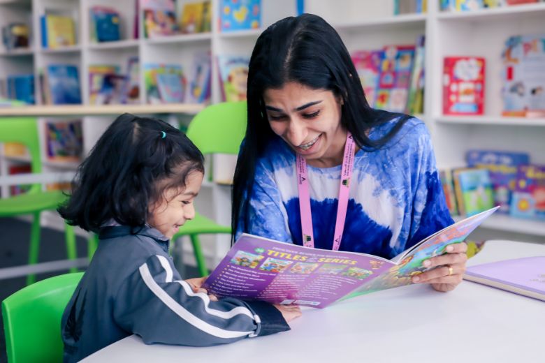 Parent reading with her child in classroom - ‘Together We Read’ initiative
