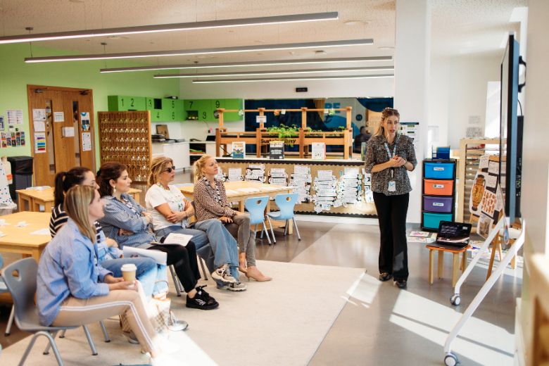 Families attending a school workshop session at Bloom World Academy