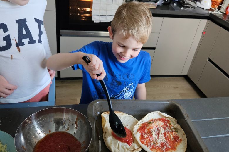 Child completing life skills activity at home with parent support