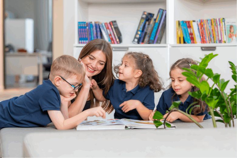 Students reading in a classroom with teacher