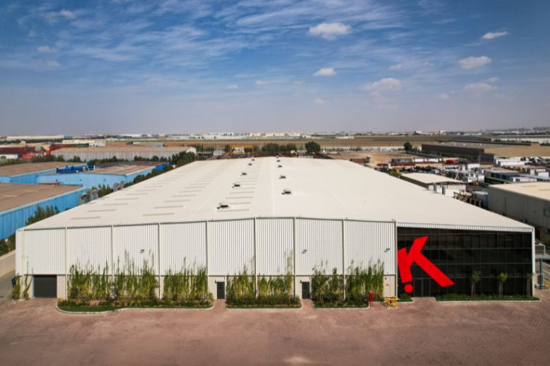 Spacious Dubai factory producing classroom furniture with skilled workers assembling desks and modular school systems