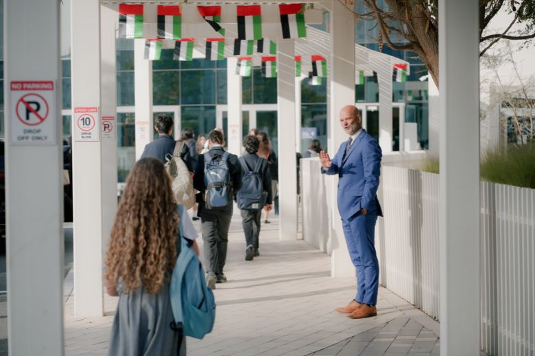 Pupils entering Repton Abu Dhabi school gates on reopening day, greeted by faculty