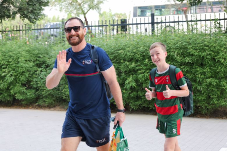 Students walking into school building at the start of the day
