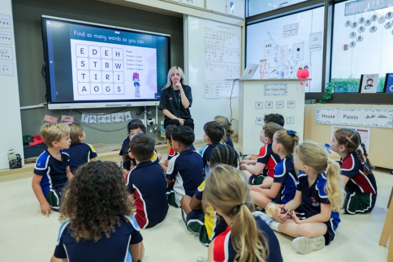 Teacher guiding young students during a classroom lesson at a Cognita UAE school