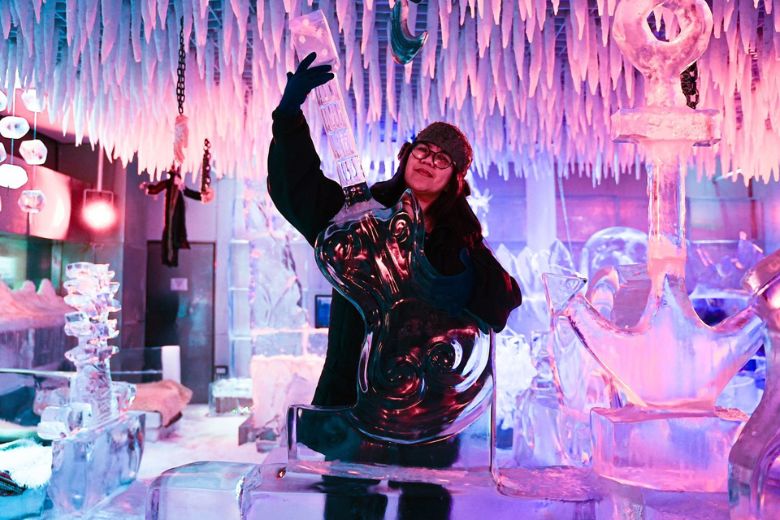 Families exploring a unique sub-zero ice lounge experience with glowing ice sculptures and frozen interiors at Times Square Center Dubai