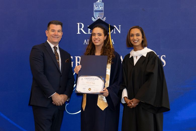 Cognita UAE Managing Director Glen Radojkovich and Repton Al Barsha Principal Chandini Misra present an award to Head Girl Laila El Rafey during the school’s inaugural A-Level graduation ceremony