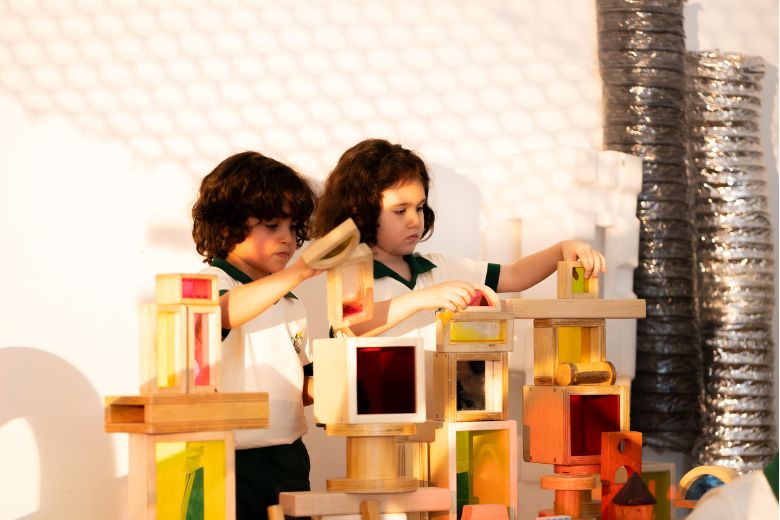 Children exploring creative art and sensory activities in a Reggio Emilia inspired classroom environment at Odyssey Nursery UAE