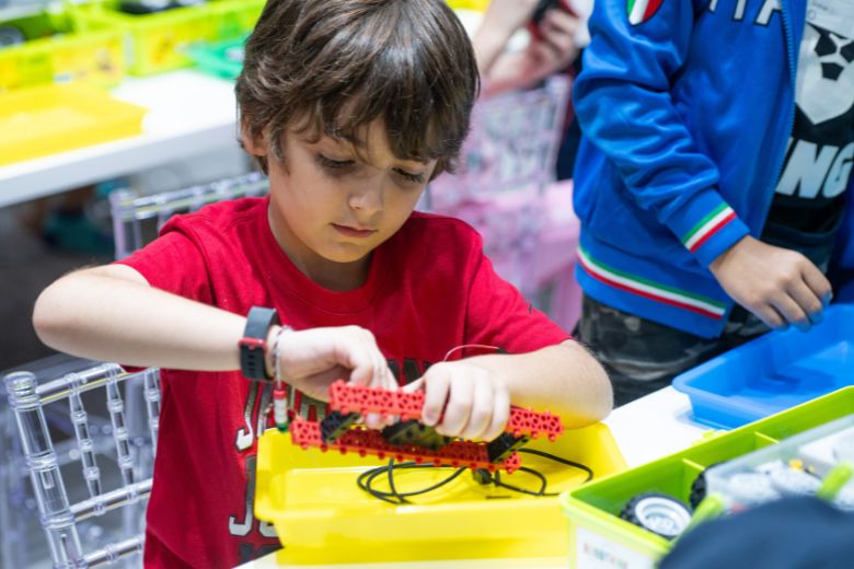 Children engaging in interactive STEM activities, exploring robotics, coding and science through playful, hands-on learning experiences