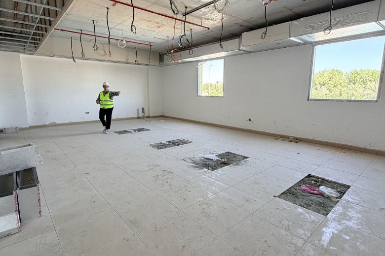 One of the school's nearly-finished classrooms, where warm tones, built-in wooden storage and carpet integrated into the floor already feel considered and calm.
